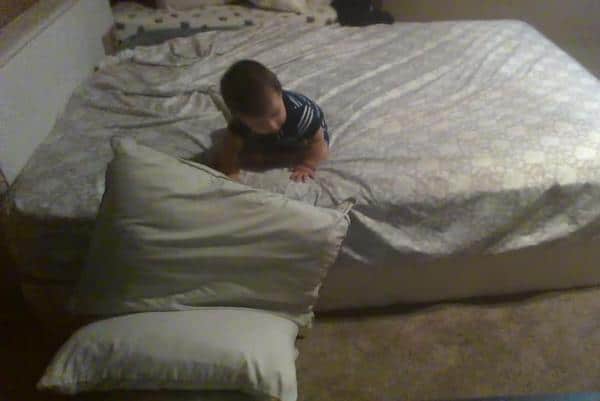 Genius-baby-uses-pillows-for-a-soft-landing-in-bed-dismount
