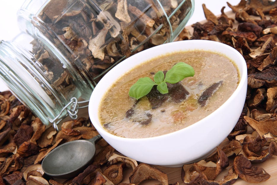 Mushroom soup, dried mushrooms and an antique spoon