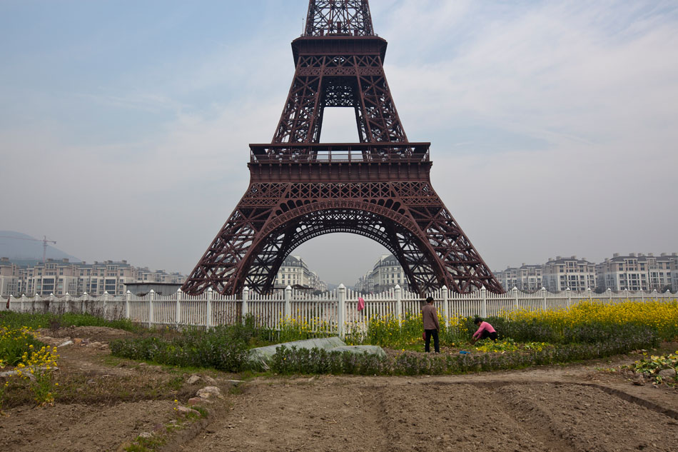 The underused and rugged green space surrounding the fake Eiffel Tower in Tianducheng is now utilized by local laborers for small garden plots