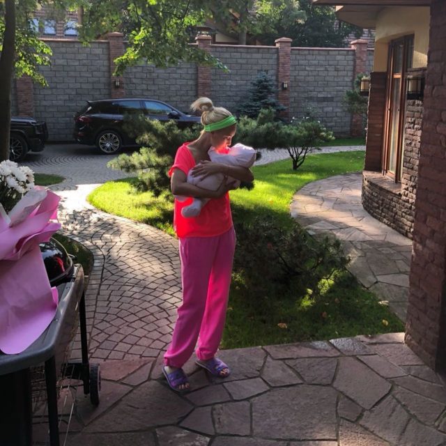 Лера Кудрявцева держит на руках маленькую дочь