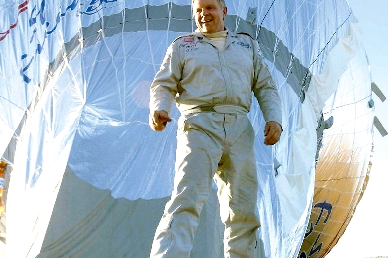 С. Фоссет в летном костюме на фоне раскрытого тормозного парашюта