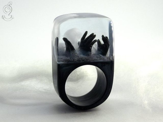 черное кольцо с украшением в виде рук