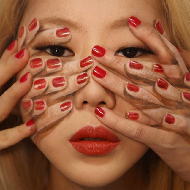 девушка азиатка с нарисованными пальцами на лице