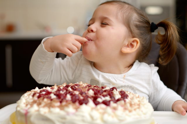 маленькая девочка ест торт