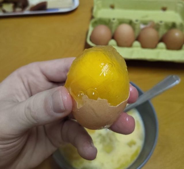 замерзшее сырое яйцо в руке
