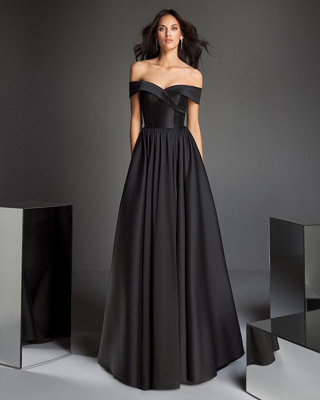 брюнетка в длинном черном платье с открытыми плечами
