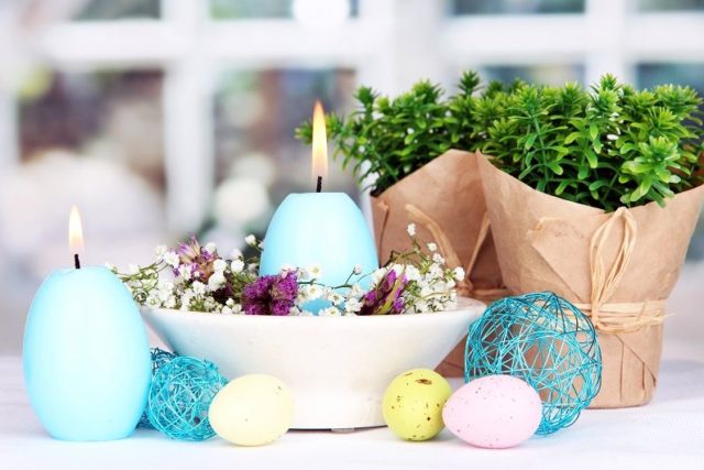 голубые свечи в форме яйца на столе